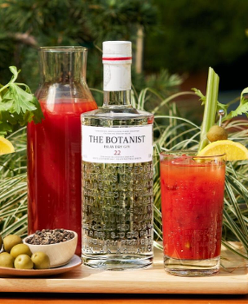 Bottle of The Botanist® Islay Dry Gin with a cocktail