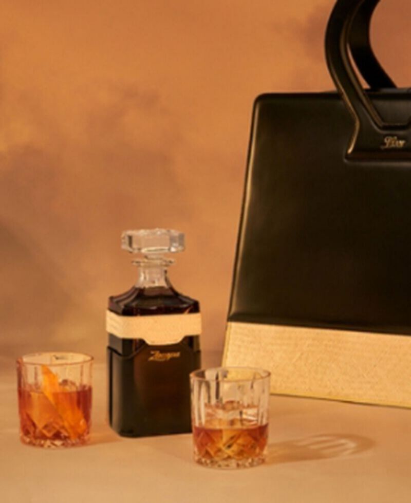 Zacapa XO, encased in a leather and petate bag inspired by Luar's iconic Ana Weekender bag with stylish accessories and a custom decanter.