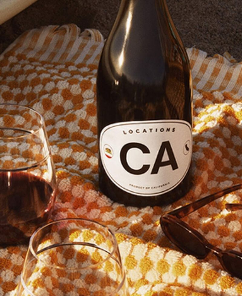 Bottle of Locations CA by Dave Phinney California Red Blend Red Wine on a picnic blanket