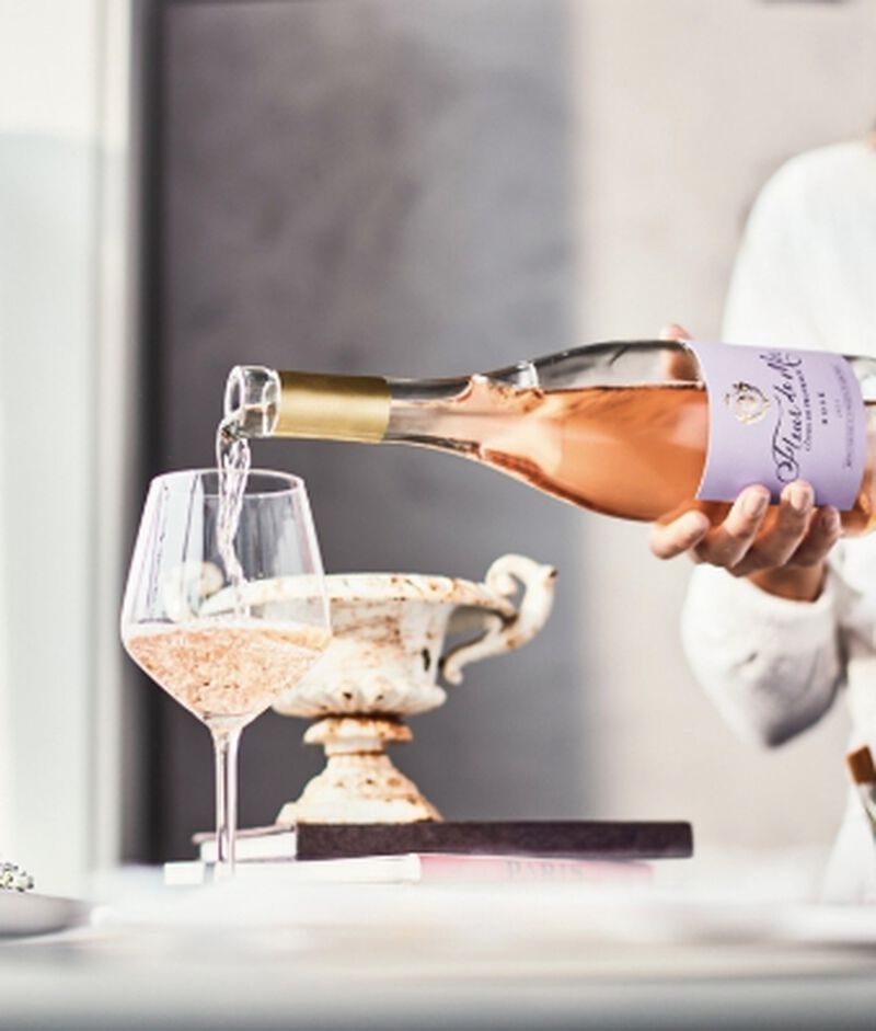 Bottle of Fleur de Mer Cotes De Provence French Rosé Wine being poured into a glass