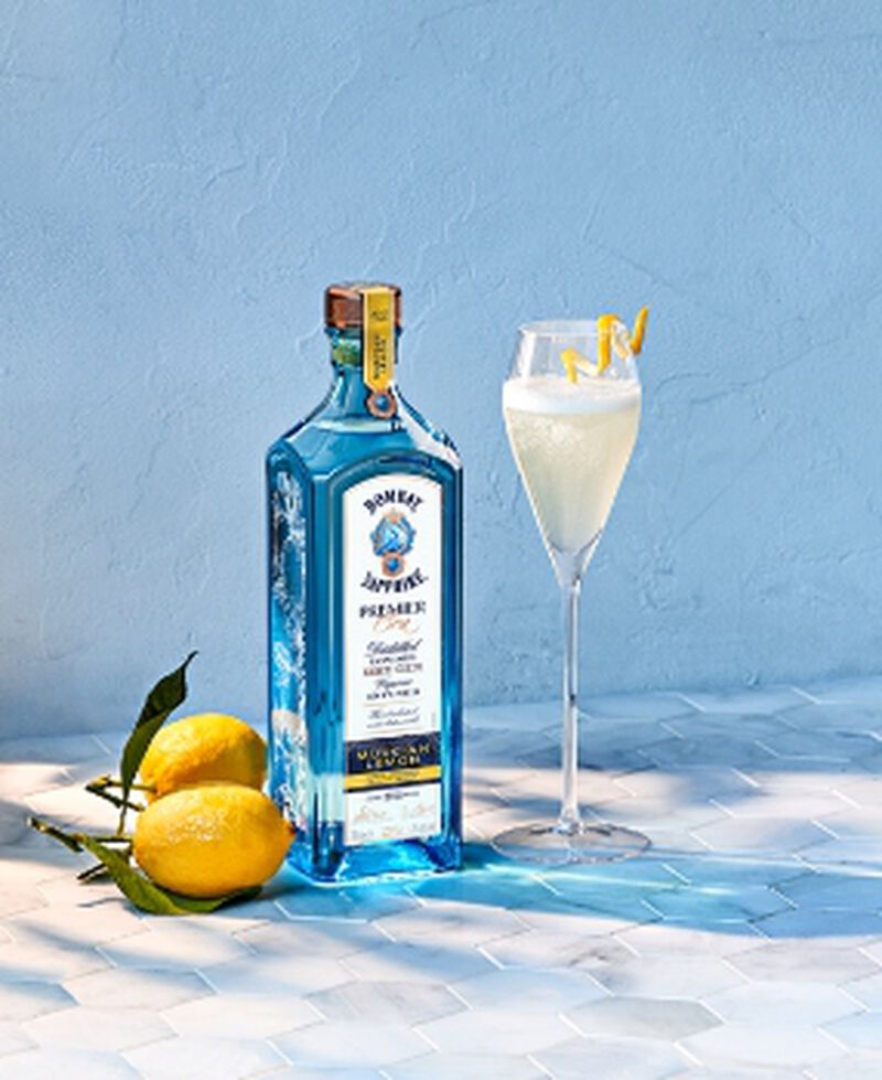 Bottle of Bombay Sapphire Premier Cru Murcian Lemon with lemons and a cocktail