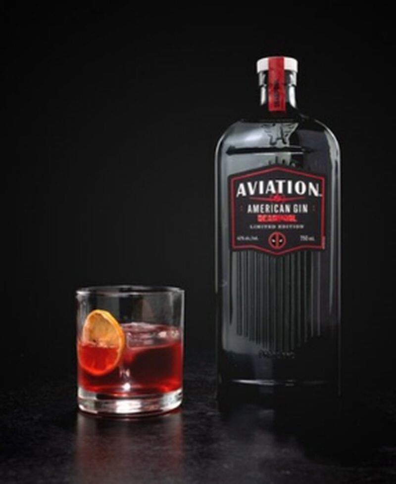 Bottle of Aviation American Gin Deadpool Limited Edition with a cocktail