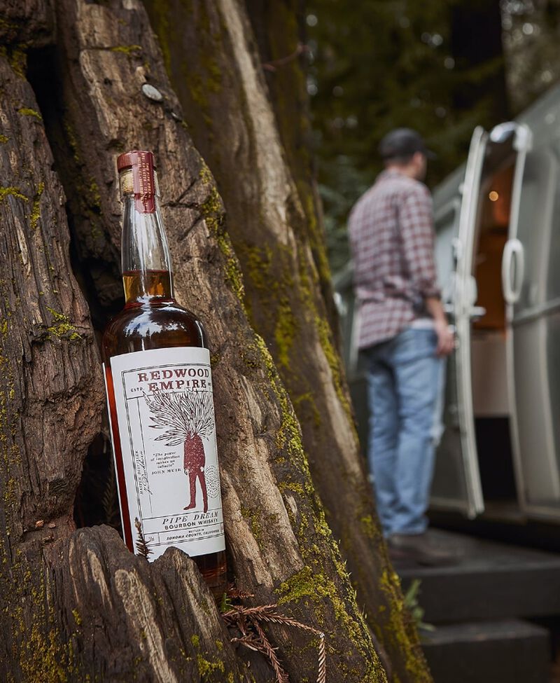 Bottle of Redwood Empire Whiskey sitting in a tree