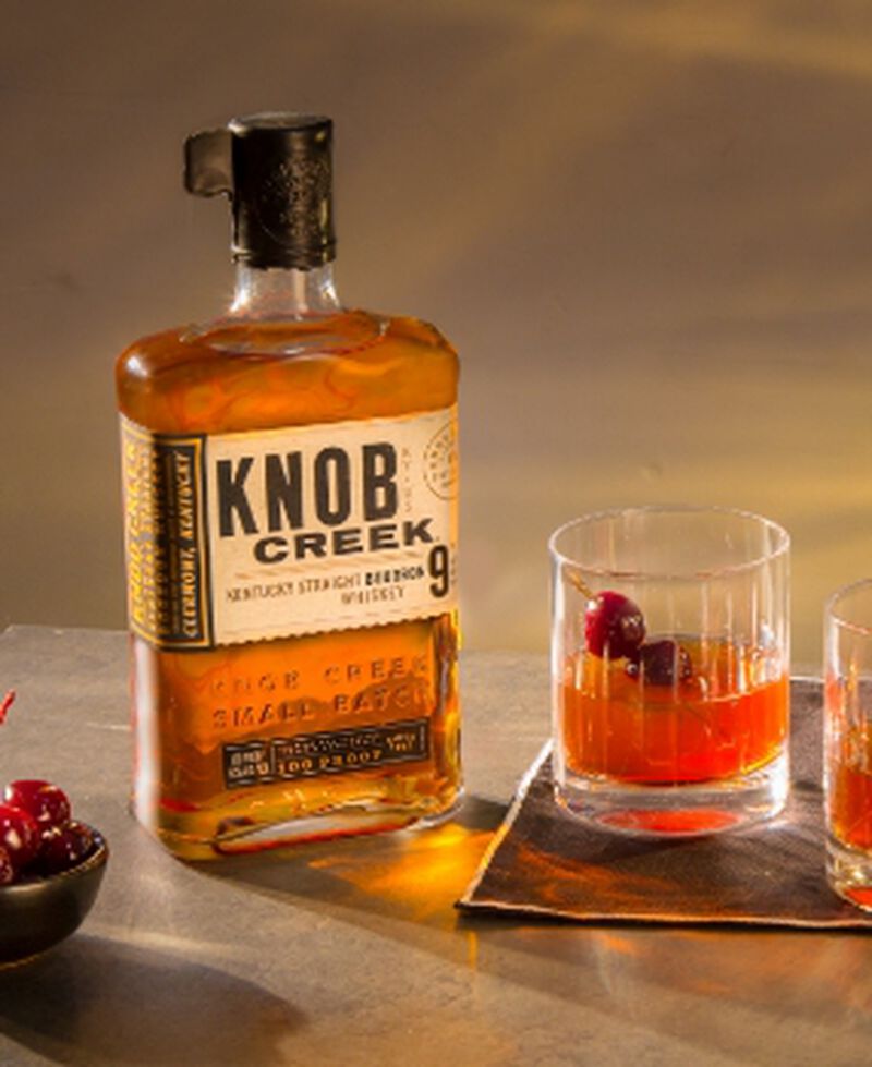 Bottle of Knob Creek with a cocktail