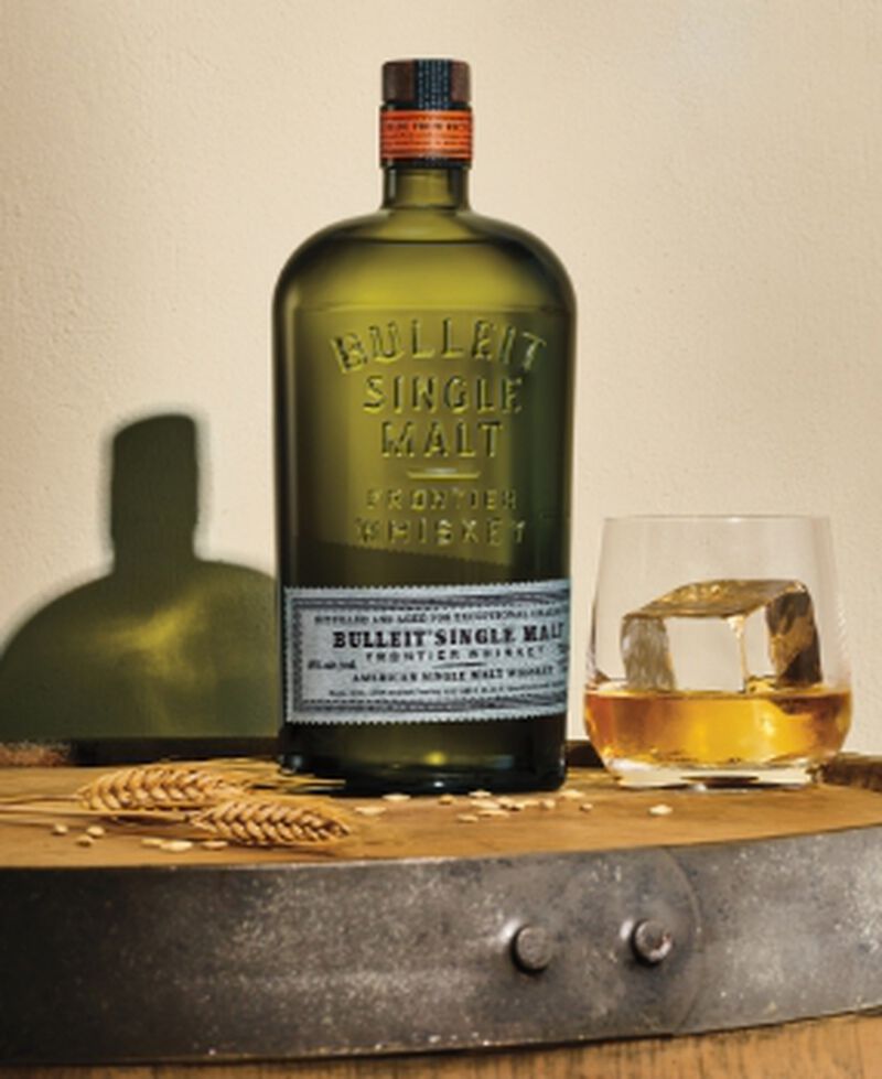 Bottle of  Bulleit American Single Malt Whiskey with a cocktail