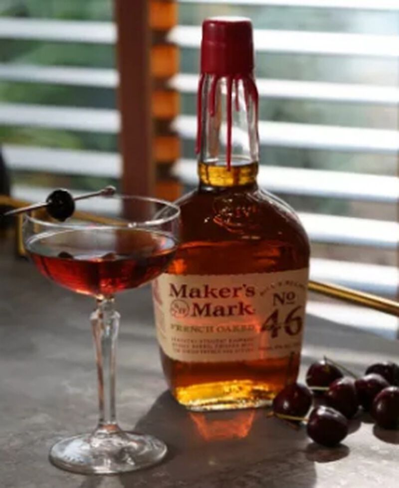 Maker's Mark bottle with a Manhattan cocktail