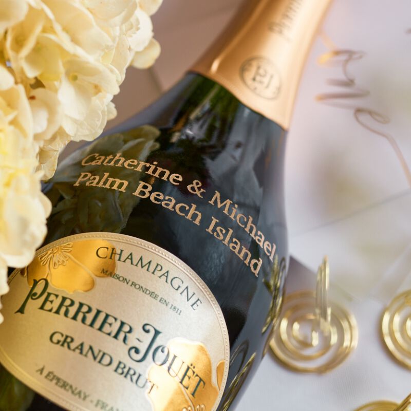 A bottle of Champagne with custom engraving for a wedding